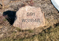 engraved address rock by driveway
